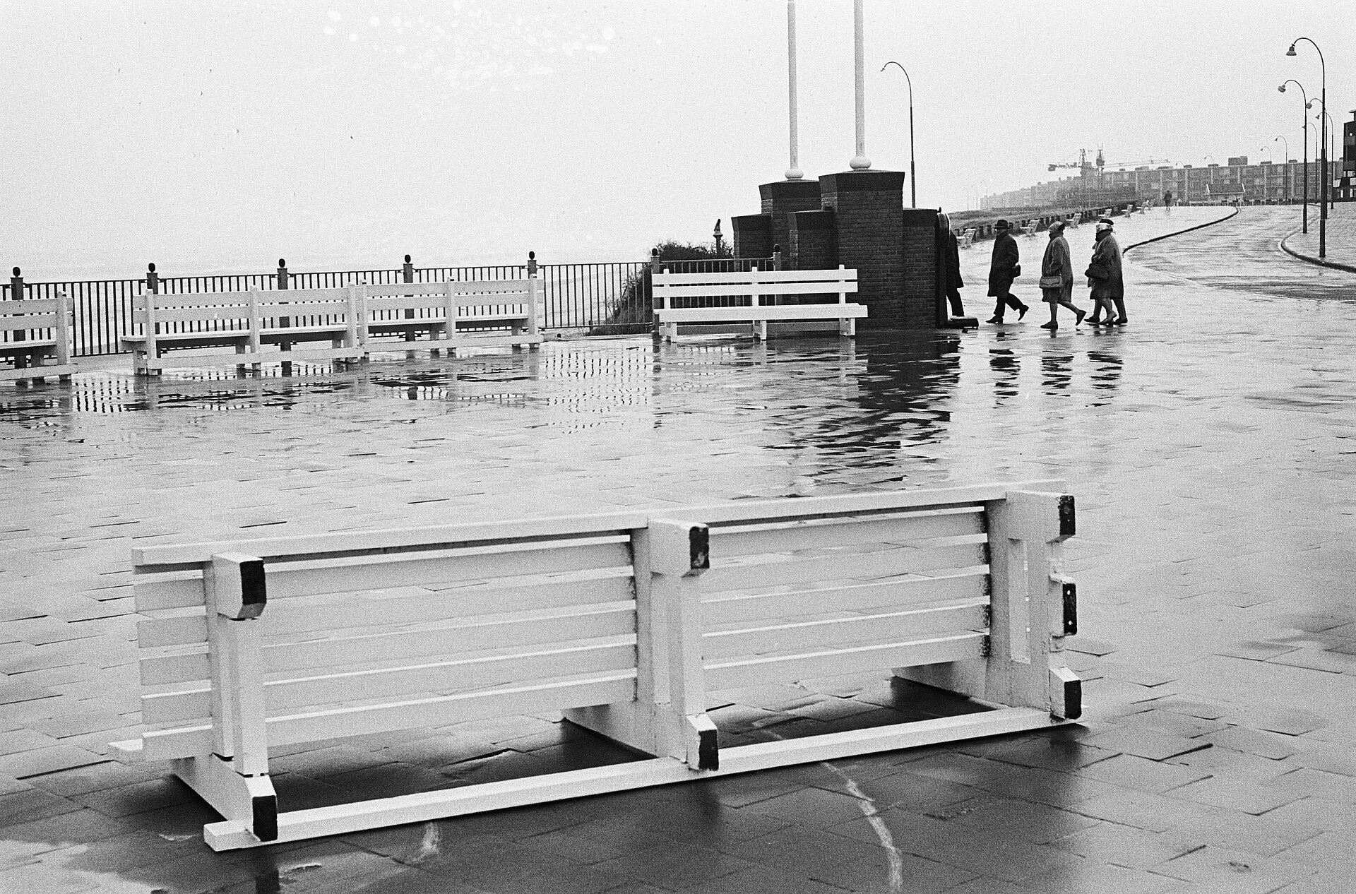Zwart-witfoto uit 1963: omgewaaide banken op de natte boulevard van Zandvoort